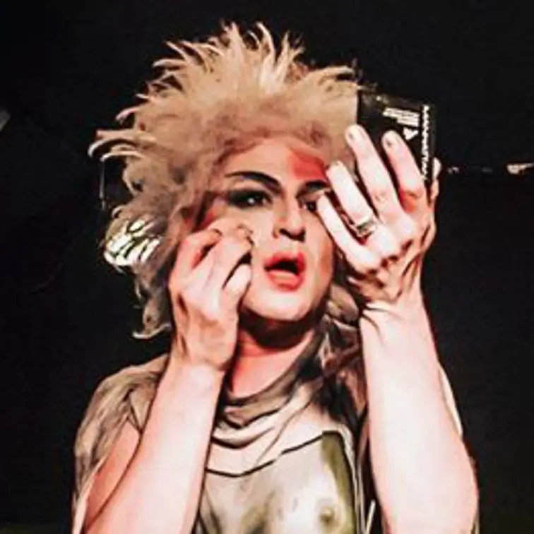 Anita putting makeup powder on face