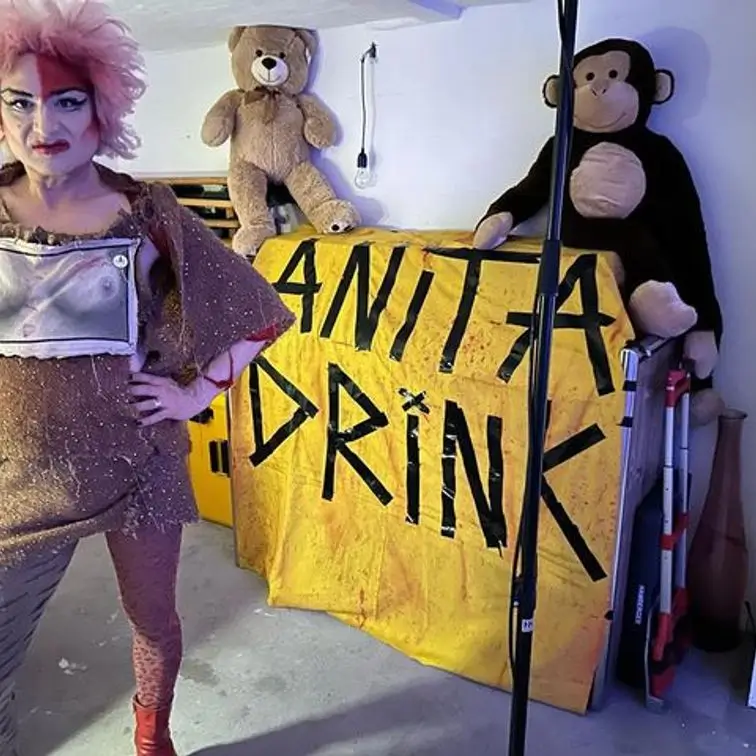 Anita posing on stage with teddy bears